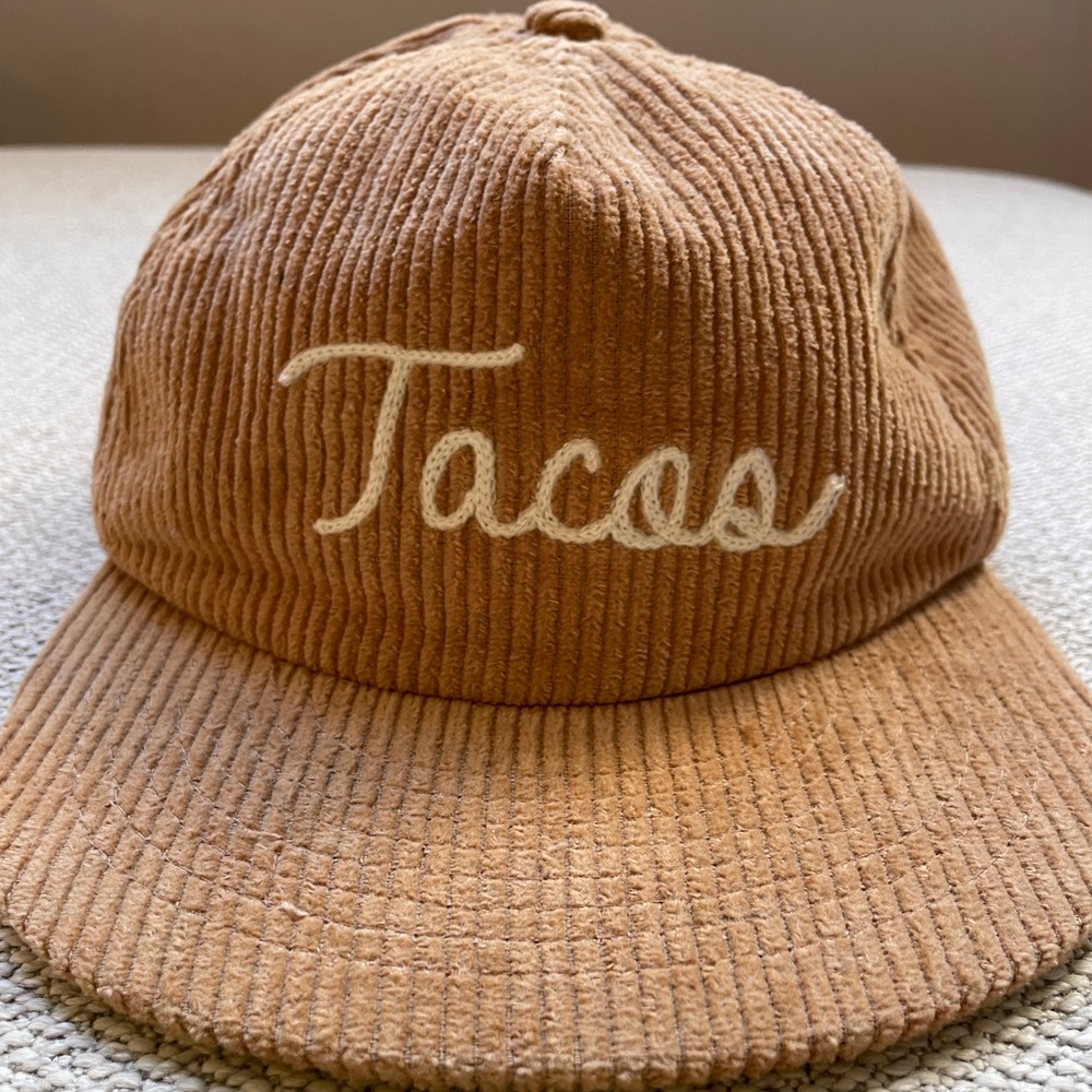 Courdouroy beige hat with “tacos” embroidered across the front.  One size.